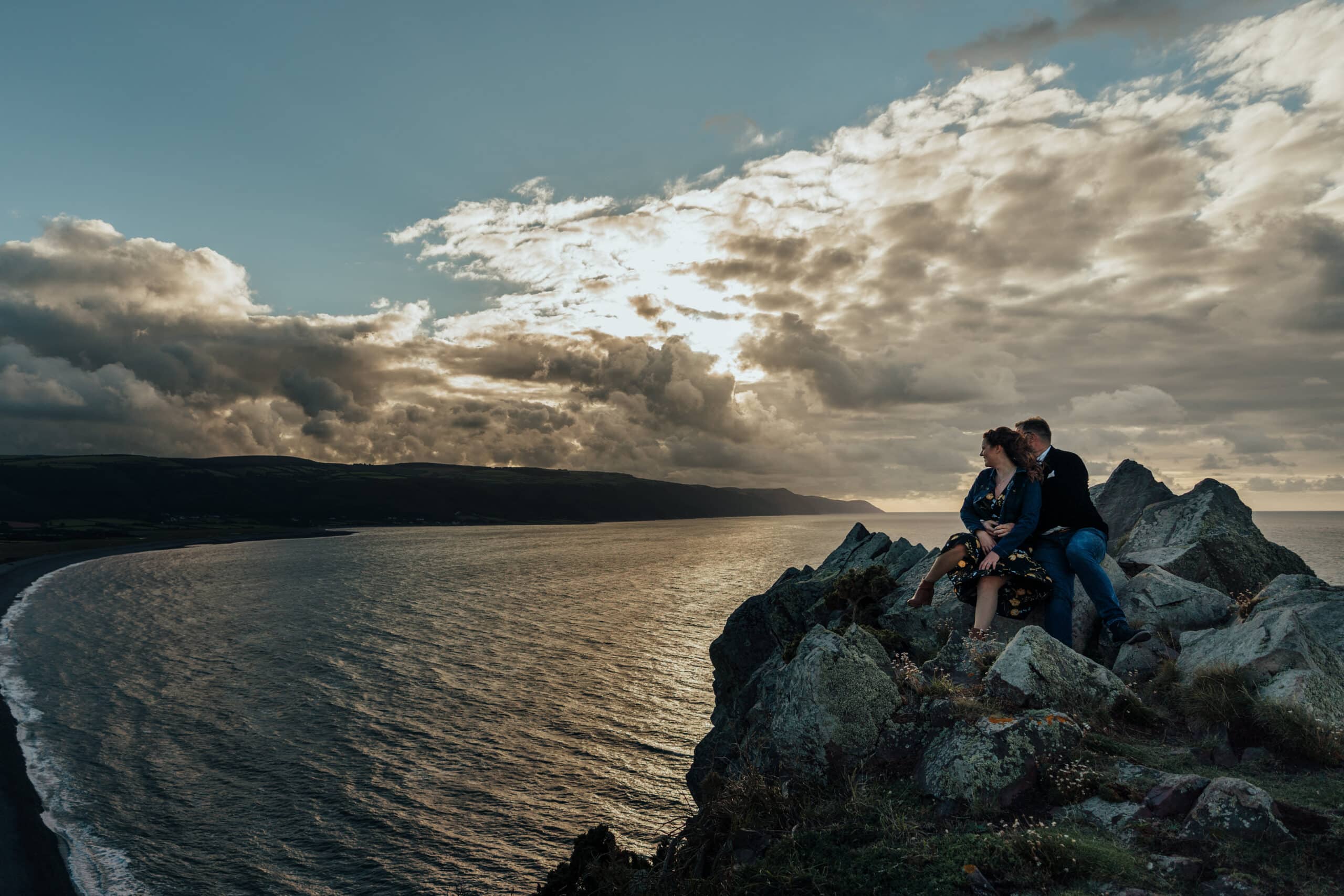 couple sat on cliff in devon