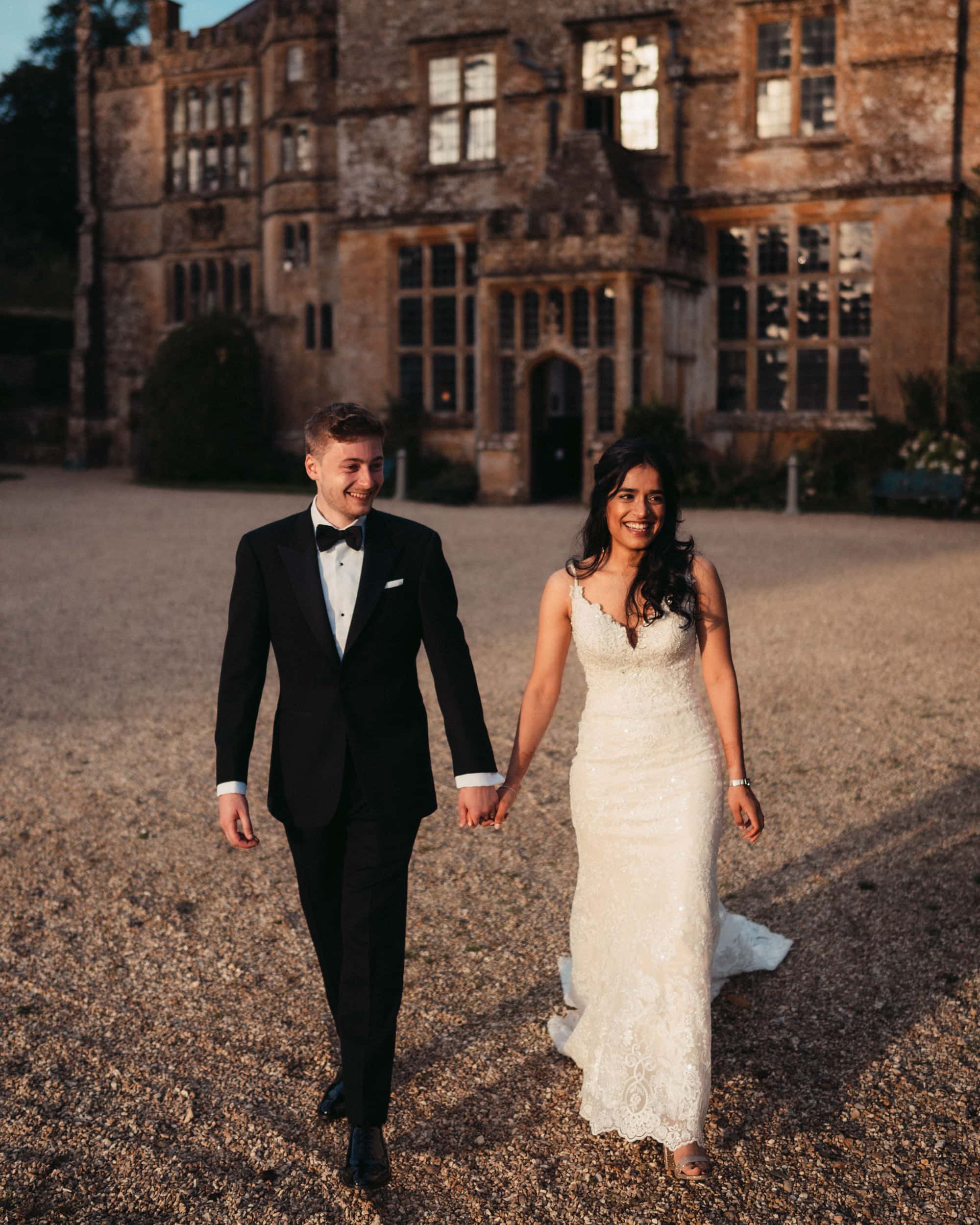 evening sunlight on newly bride and groom in Yeovil Somerset outside a grand house