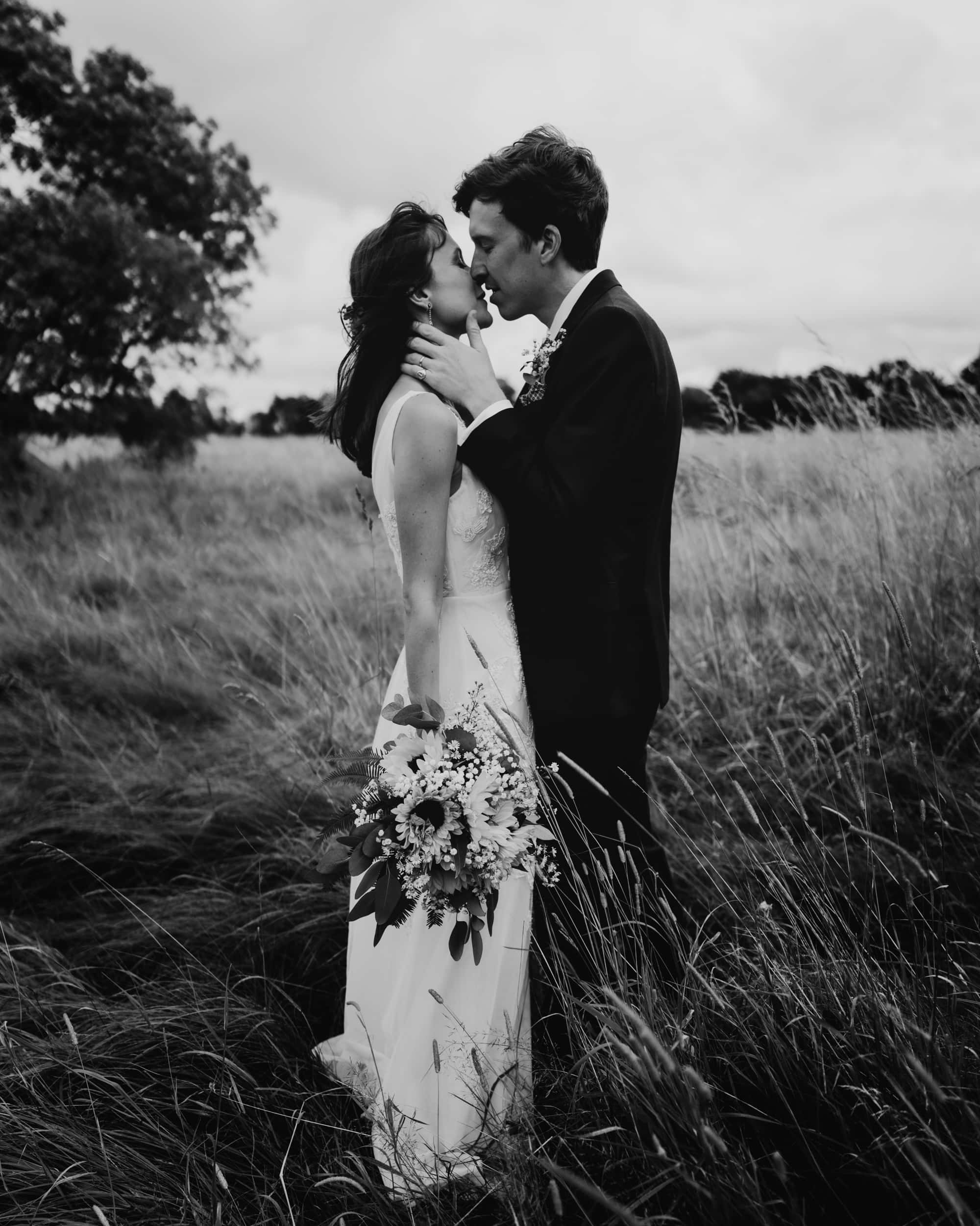 couple kissing in long grass